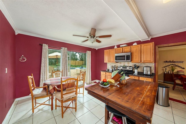 tiled dining space with crown molding, a textured ceiling, and ceiling fan