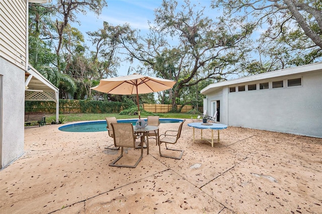 view of patio / terrace with a fenced in pool