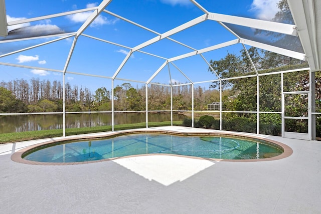 pool with a water view, glass enclosure, and a patio