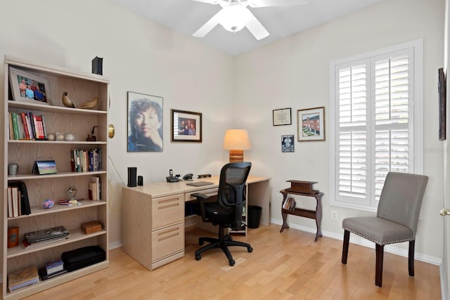 home office featuring a ceiling fan, light wood-type flooring, and baseboards