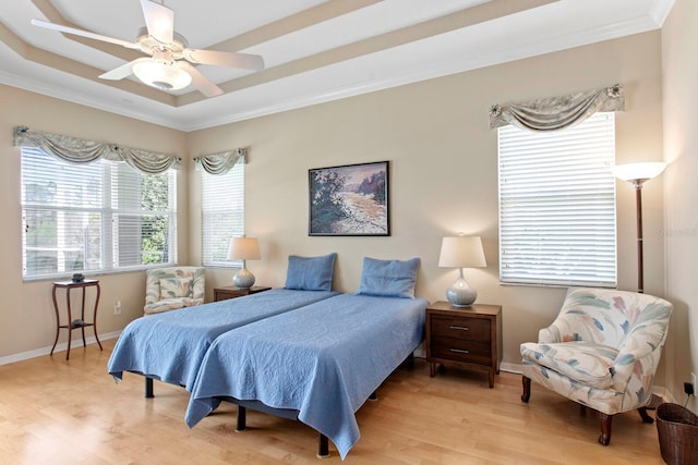 bedroom with crown molding, baseboards, and light wood-style floors