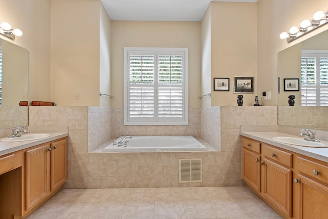 bathroom with a bath, tile walls, visible vents, and a sink