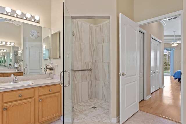 full bathroom with visible vents, a stall shower, tile patterned flooring, and vanity