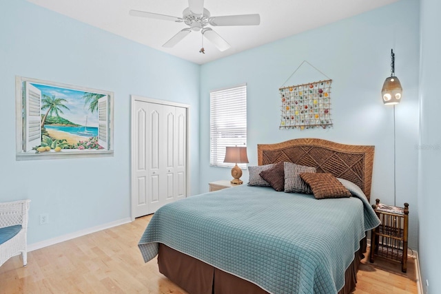 bedroom featuring a closet, baseboards, ceiling fan, and light wood finished floors