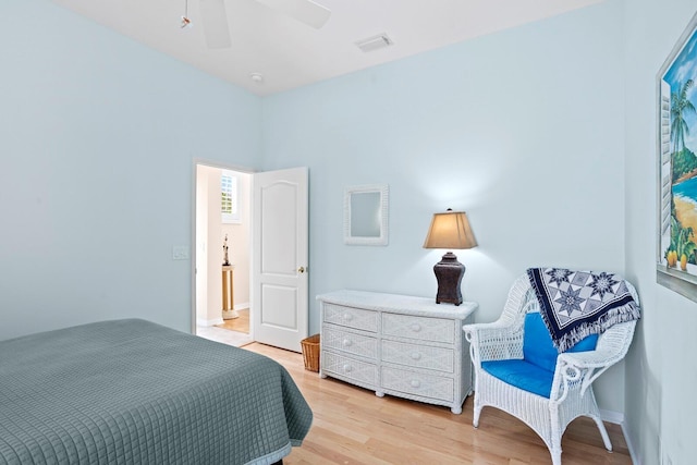 bedroom featuring light wood-style flooring, visible vents, and ceiling fan