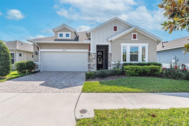 view of front of house featuring a garage and a front lawn