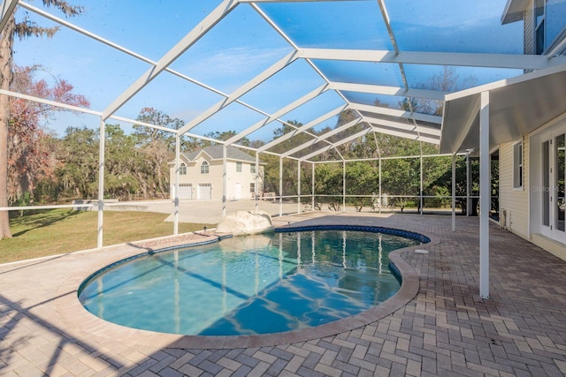 pool featuring glass enclosure and a patio area