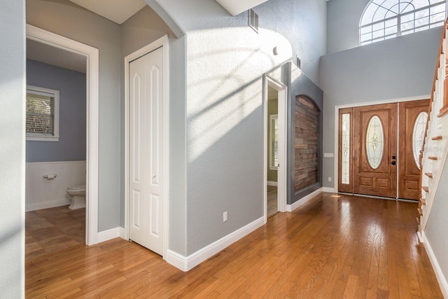 entryway with wood-type flooring, visible vents, and baseboards