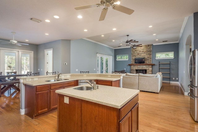 kitchen with a spacious island, open floor plan, a fireplace, and a sink