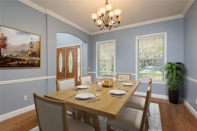 dining room featuring baseboards, ornamental molding, and wood finished floors