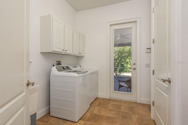 laundry area with cabinet space, baseboards, and washing machine and clothes dryer