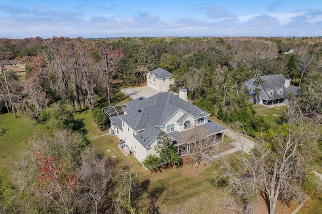 bird's eye view featuring a wooded view