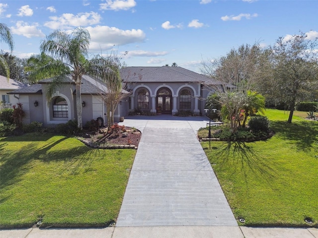 mediterranean / spanish house featuring a front yard