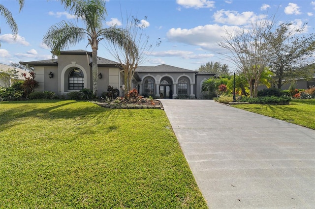 mediterranean / spanish-style home featuring a front lawn