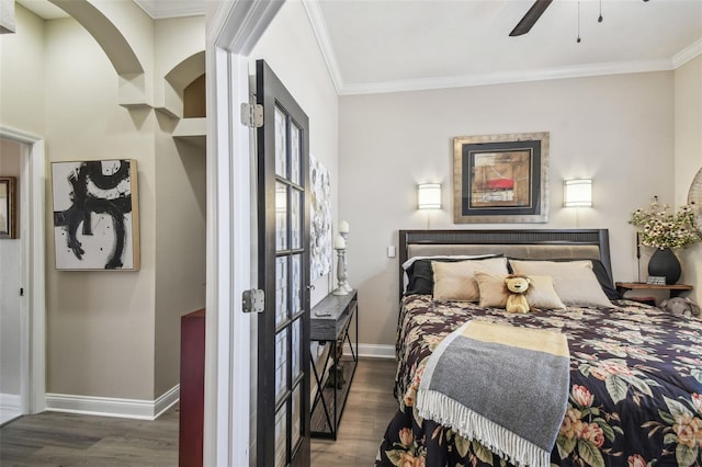 bedroom featuring dark wood-type flooring, ceiling fan, and crown molding