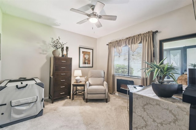 office area featuring light colored carpet and ceiling fan