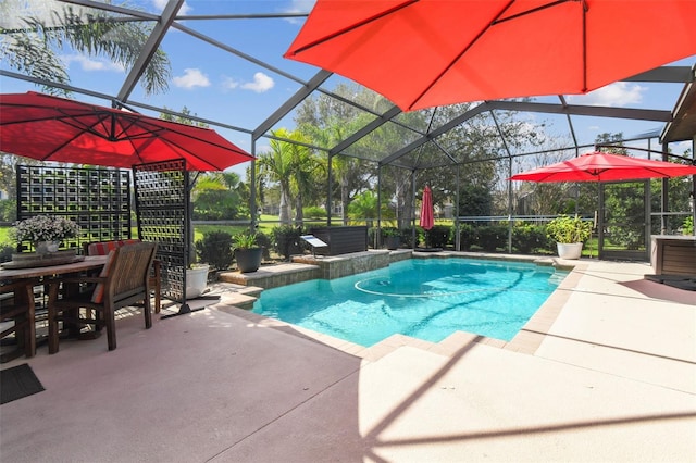 view of pool with a patio and a lanai