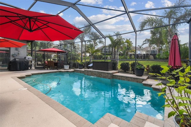 outdoor pool with a lanai and a patio area
