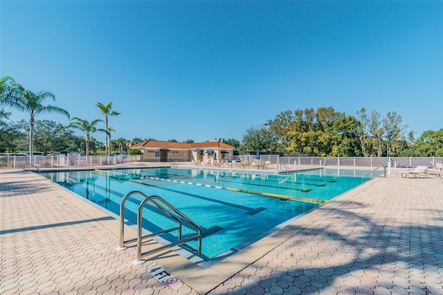 community pool featuring fence and a patio area