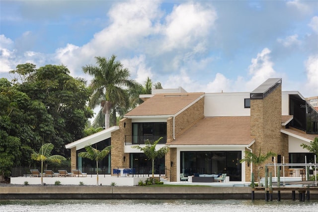 rear view of house with an outdoor hangout area