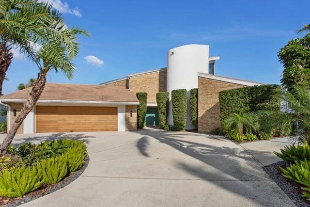 contemporary house with concrete driveway and an attached garage