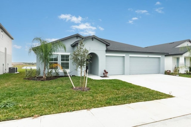 ranch-style house with cooling unit, a garage, and a front yard