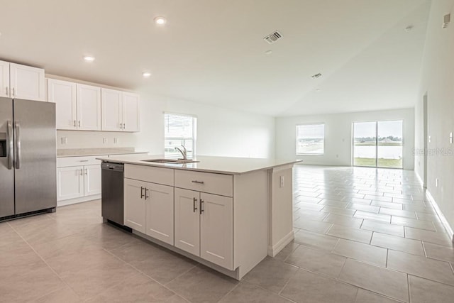 kitchen featuring white cabinetry, stainless steel appliances, sink, and a center island with sink