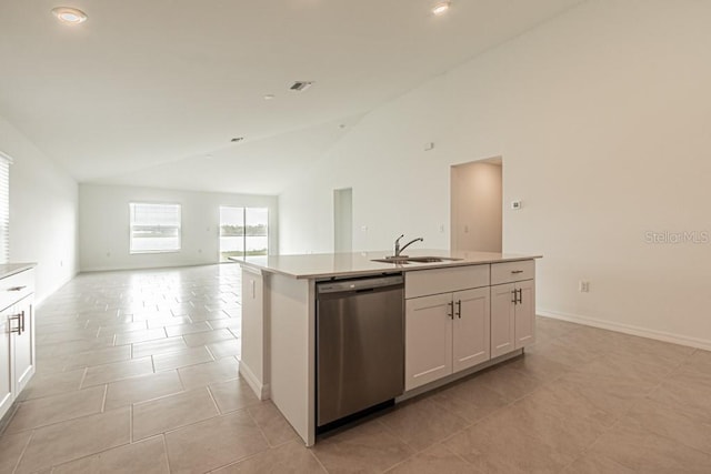 kitchen featuring sink, light tile patterned floors, white cabinetry, a center island with sink, and stainless steel dishwasher