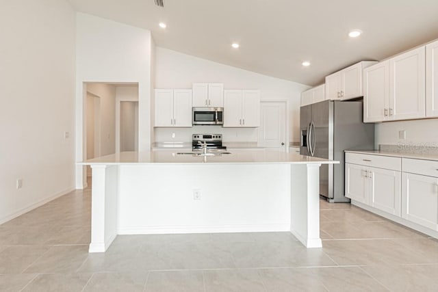 kitchen featuring stainless steel appliances, a kitchen island with sink, sink, and white cabinets