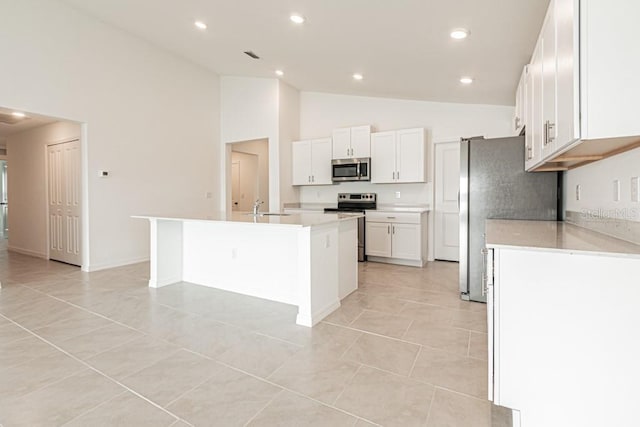 kitchen featuring a kitchen island with sink, sink, white cabinets, and appliances with stainless steel finishes