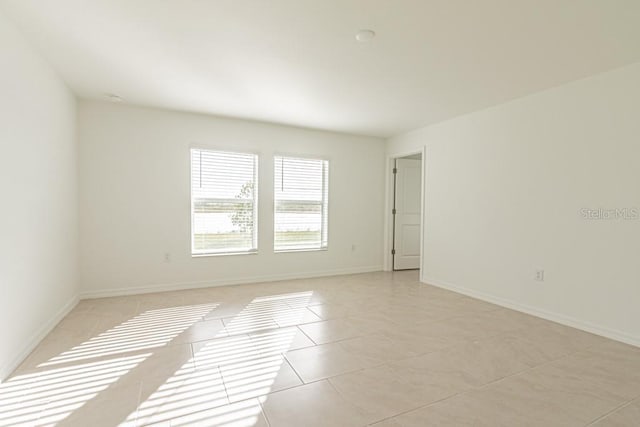 spare room featuring light tile patterned floors