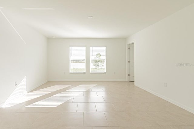 unfurnished room featuring light tile patterned floors