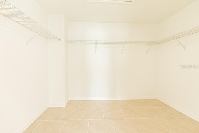 walk in closet with tile patterned floors