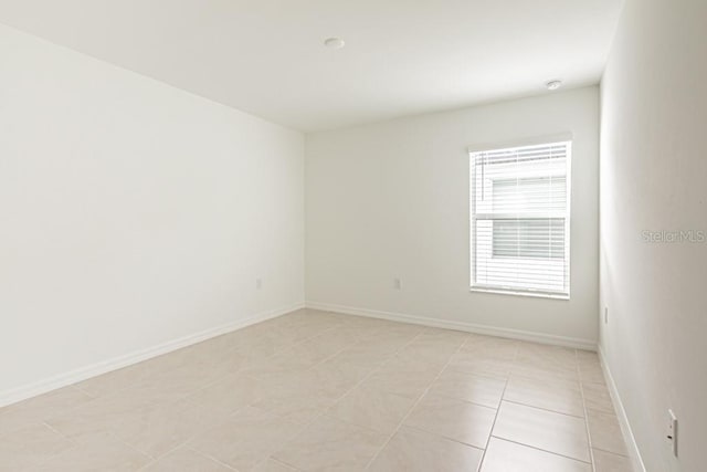 unfurnished room featuring light tile patterned floors