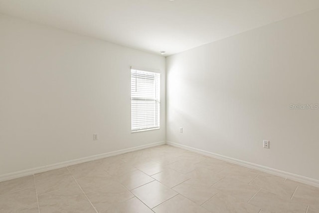 spare room with light tile patterned floors