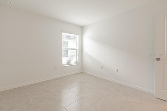 unfurnished room with light tile patterned floors