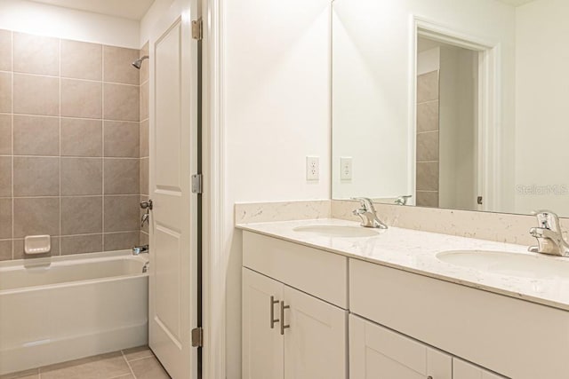 bathroom featuring tiled shower / bath, tile patterned floors, and vanity