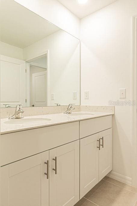 bathroom with tile patterned floors and vanity