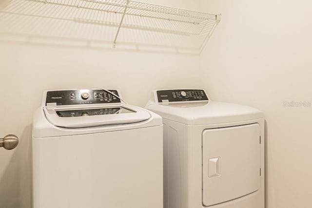 washroom featuring independent washer and dryer