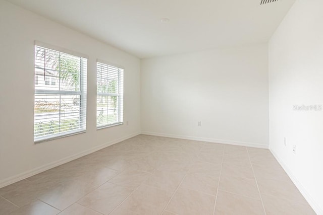 spare room with light tile patterned floors