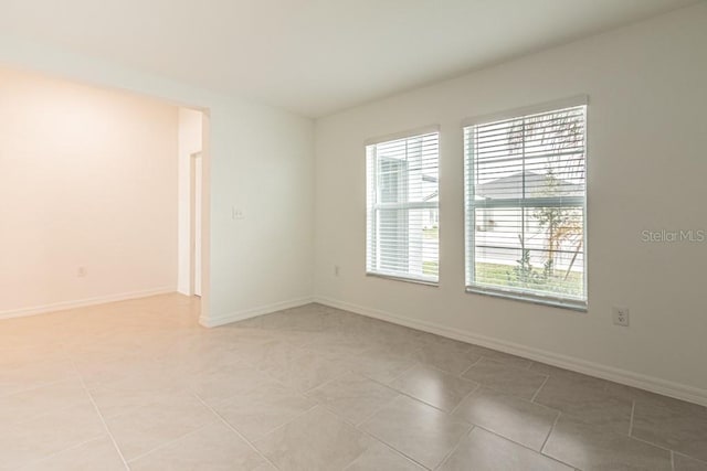 spare room with light tile patterned flooring