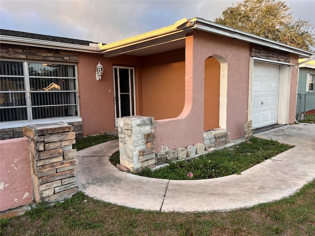 doorway to property with a garage