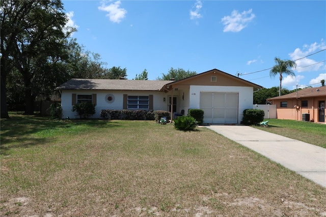 ranch-style house with a garage, central air condition unit, and a front lawn