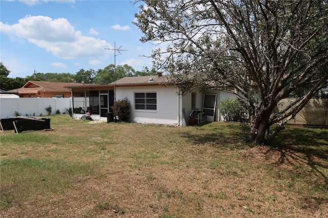 back of house with a yard