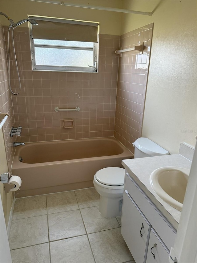 full bathroom with vanity, tile patterned floors, toilet, and tiled shower / bath