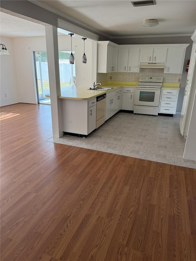 kitchen featuring hanging light fixtures, stainless steel dishwasher, white cabinets, and white range with electric stovetop