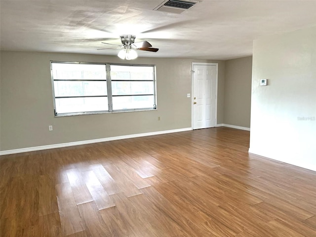 spare room featuring hardwood / wood-style floors and ceiling fan