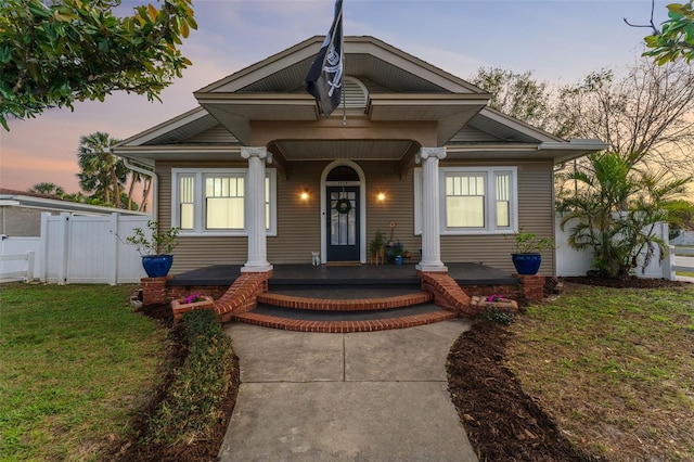 view of front of home with a yard and covered porch