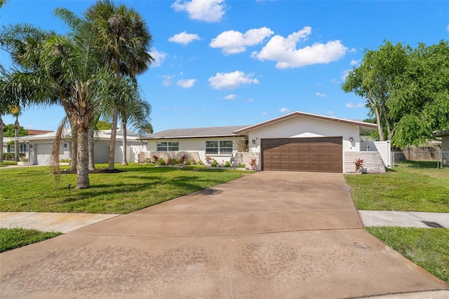 ranch-style home featuring a garage and a front yard