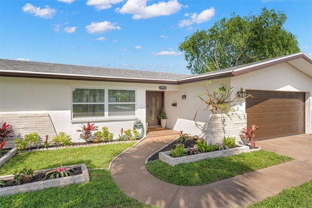 ranch-style home featuring a garage and a front lawn